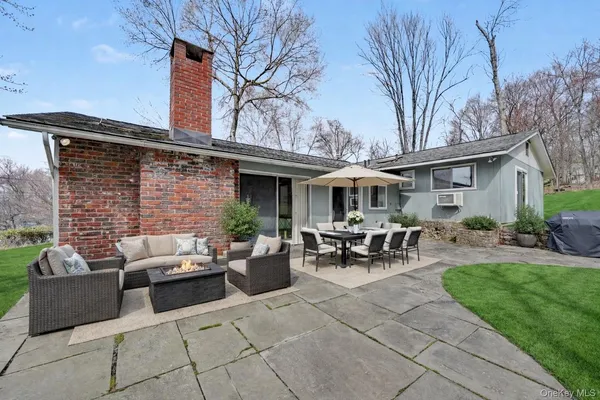 a backyard of a house with outdoor seating