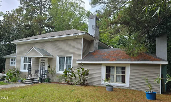 a front view of a house with a garden