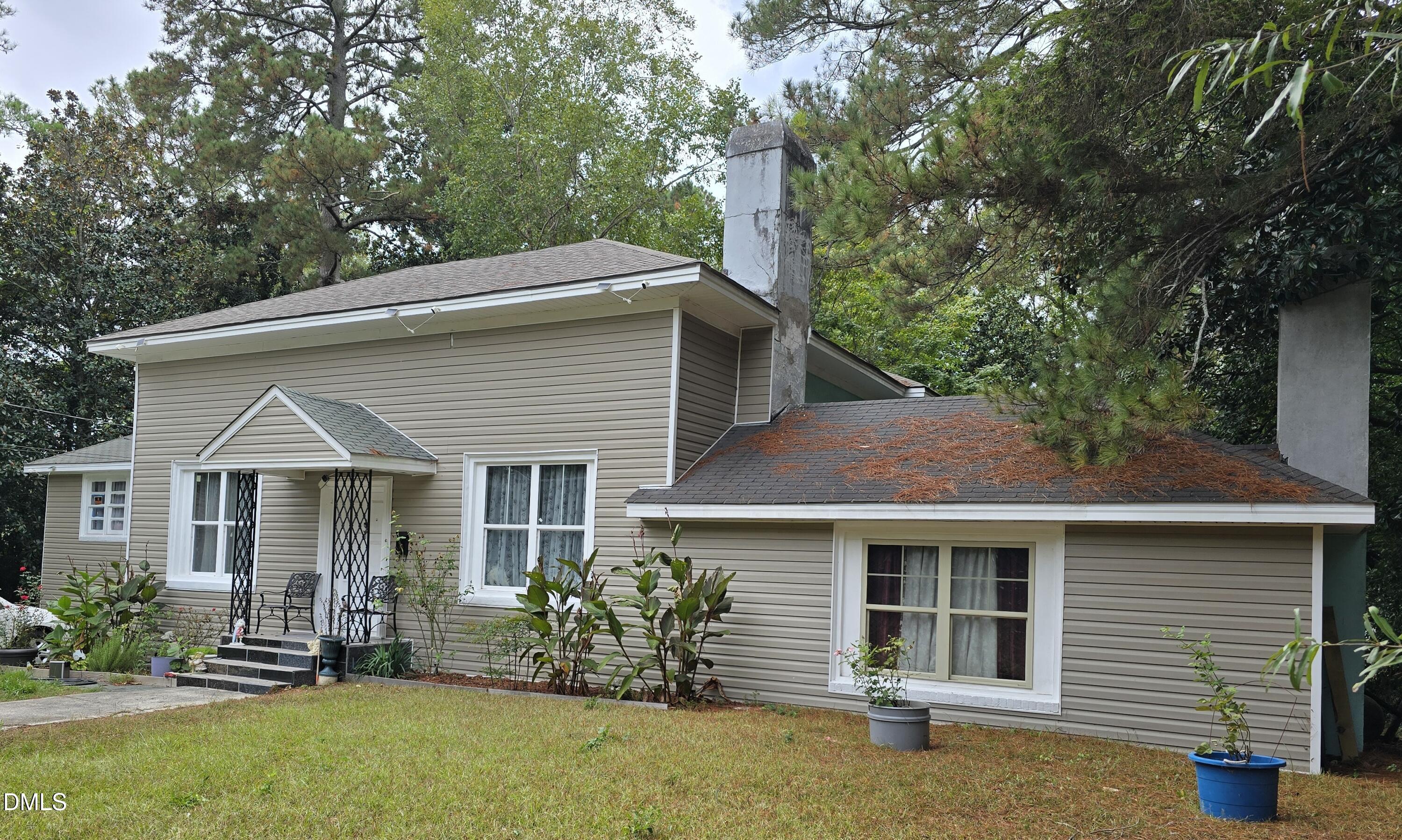 a front view of a house with a garden