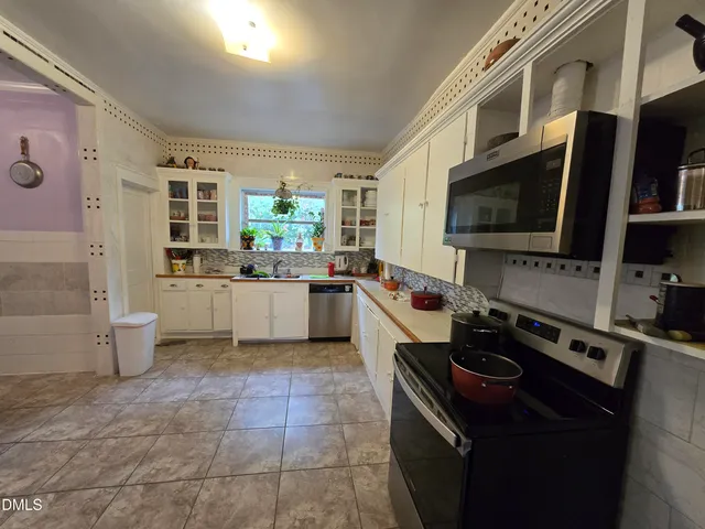 a kitchen with stainless steel appliances granite countertop a stove and a sink