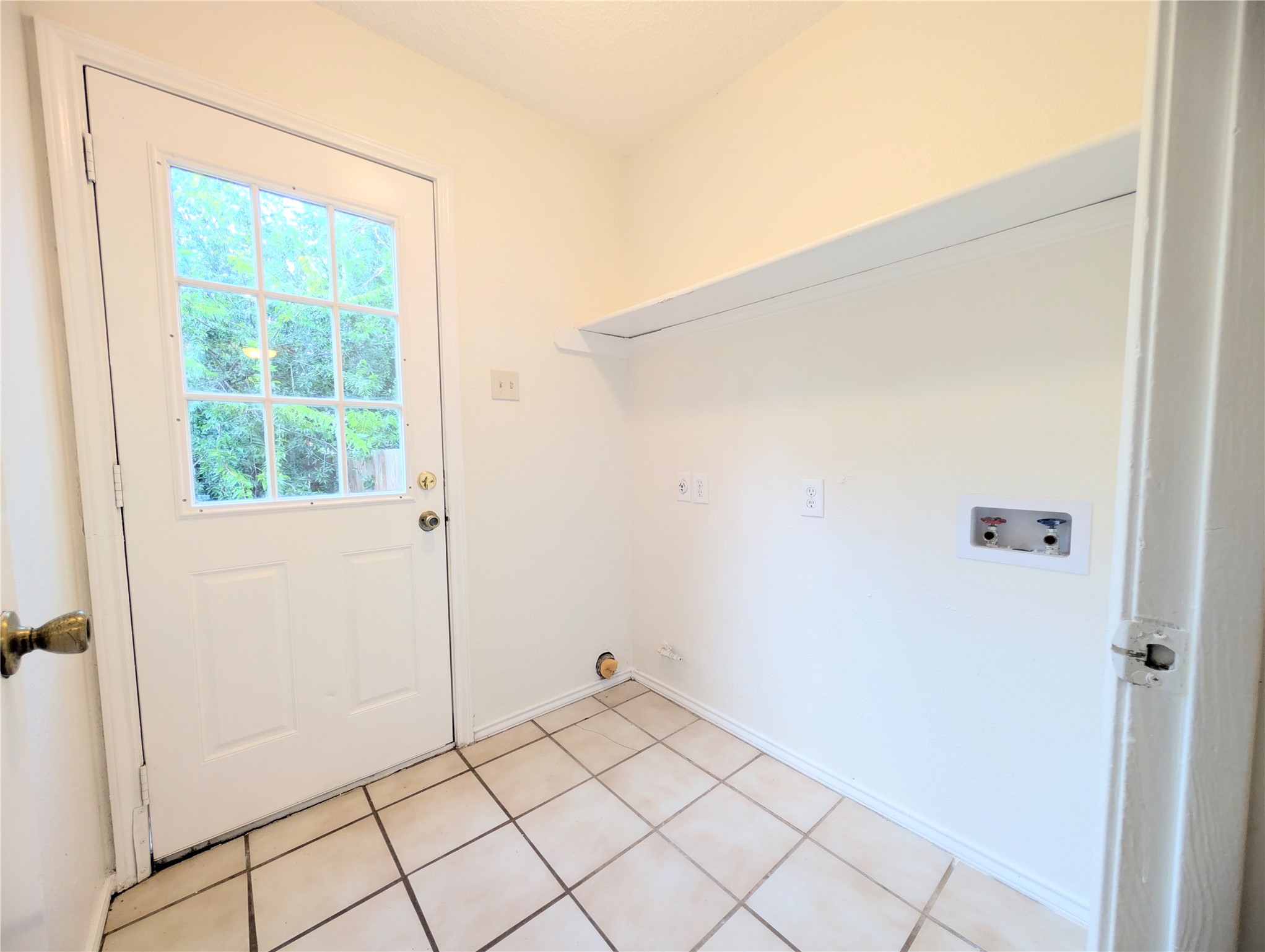2016 Redwing Way Round Rock, TX 78664 - Photo 7 of 19 Functional laundry room offers a convenient outdoor access and tiled flooring for practical living.