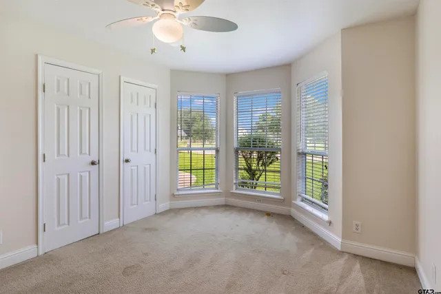 an empty room with windows and outdoor view