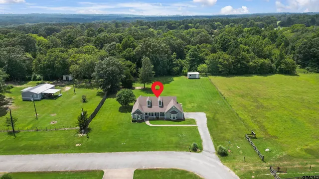 a backyard of a house with a yard and outdoor seating