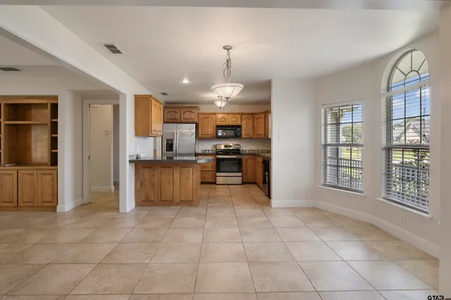 a large kitchen with cabinets and a stainless steel appliances