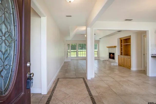a view of a hallway with wooden shelves