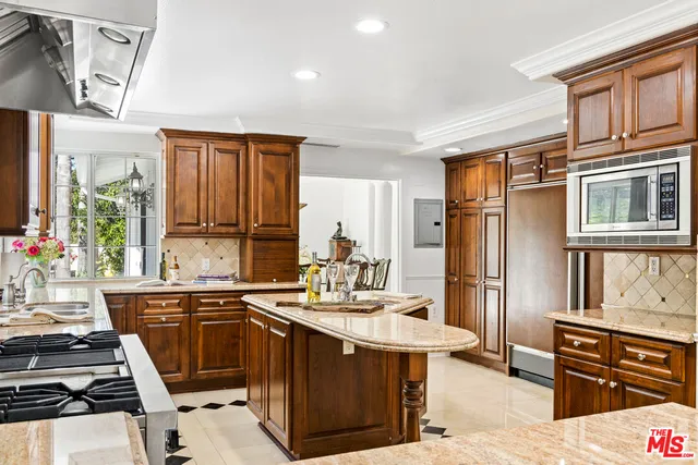 a kitchen with a sink stove and microwave