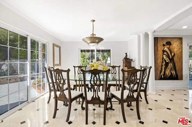a living room with granite countertop kitchen island stainless steel appliances furniture a fireplace and a sink