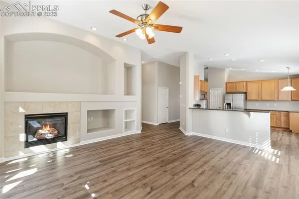 a view of a kitchen with a sink and a fireplace