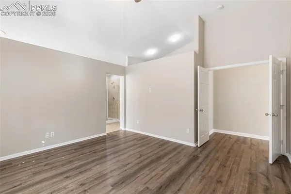 a view of an empty room with wooden floor