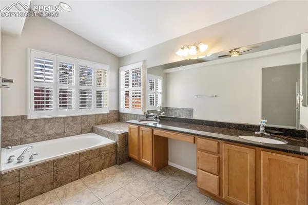 a spacious bathroom with a large tub and double vanity