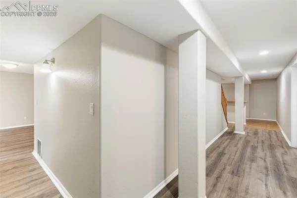 a view of hallway with wooden floor