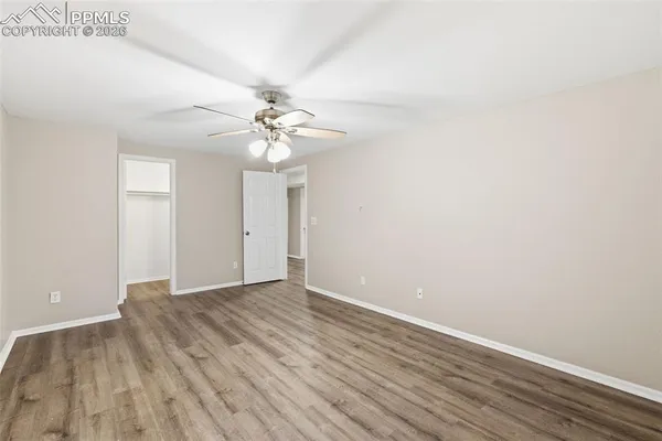 a view of an empty room with wooden floor