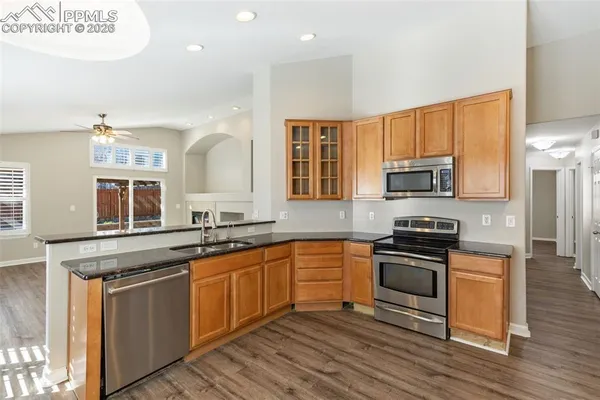 a kitchen with stainless steel appliances granite countertop a sink stove and microwave