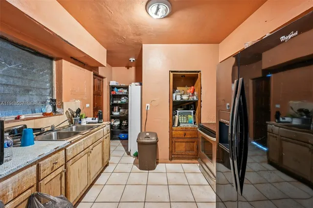 a kitchen with stainless steel appliances granite countertop a refrigerator and a sink