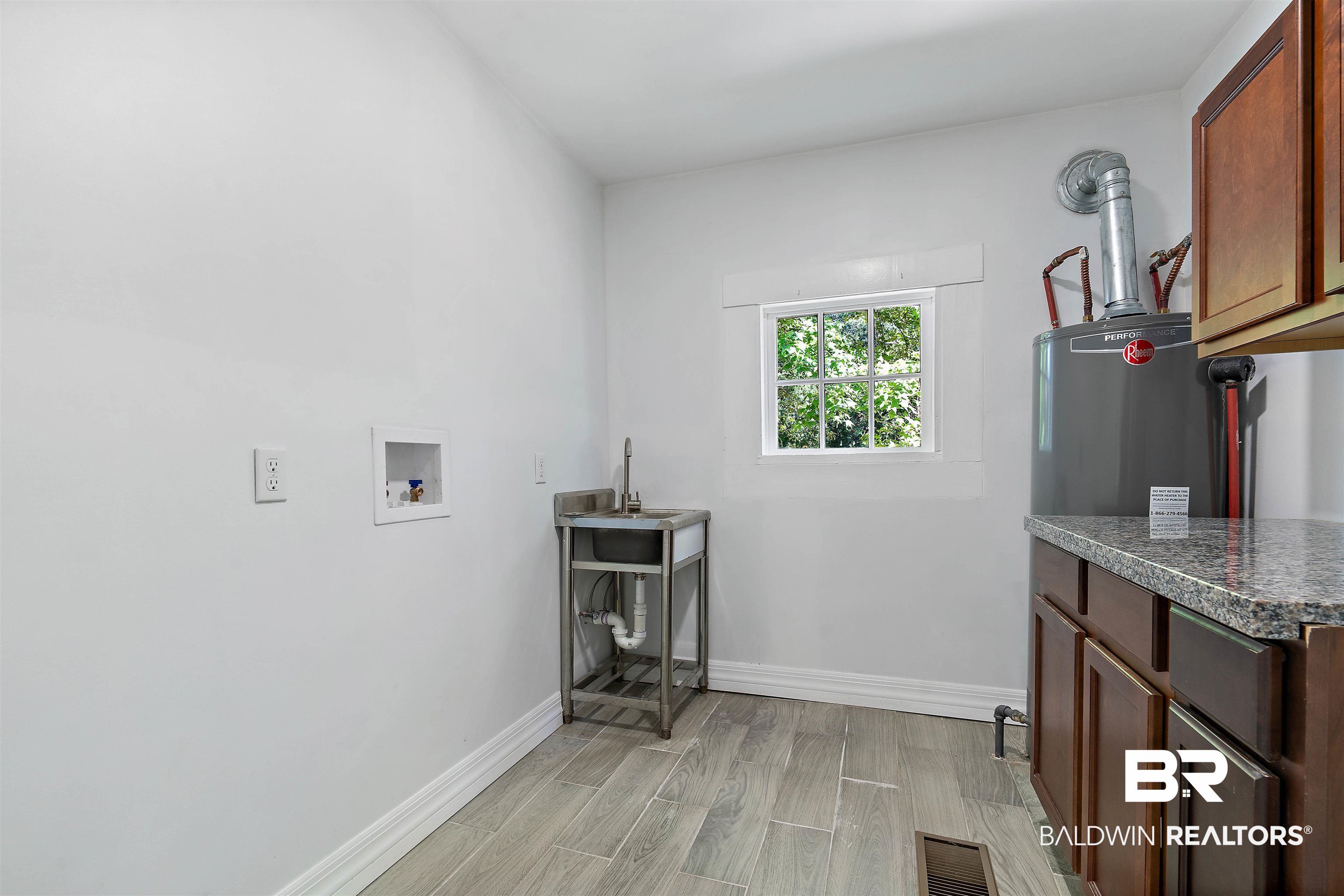 407 East 2nd Street Bay Minette, AL 36507 - Photo 32 of 40 Laundry area with cabinet space, wood tiled floors, and washer hookup