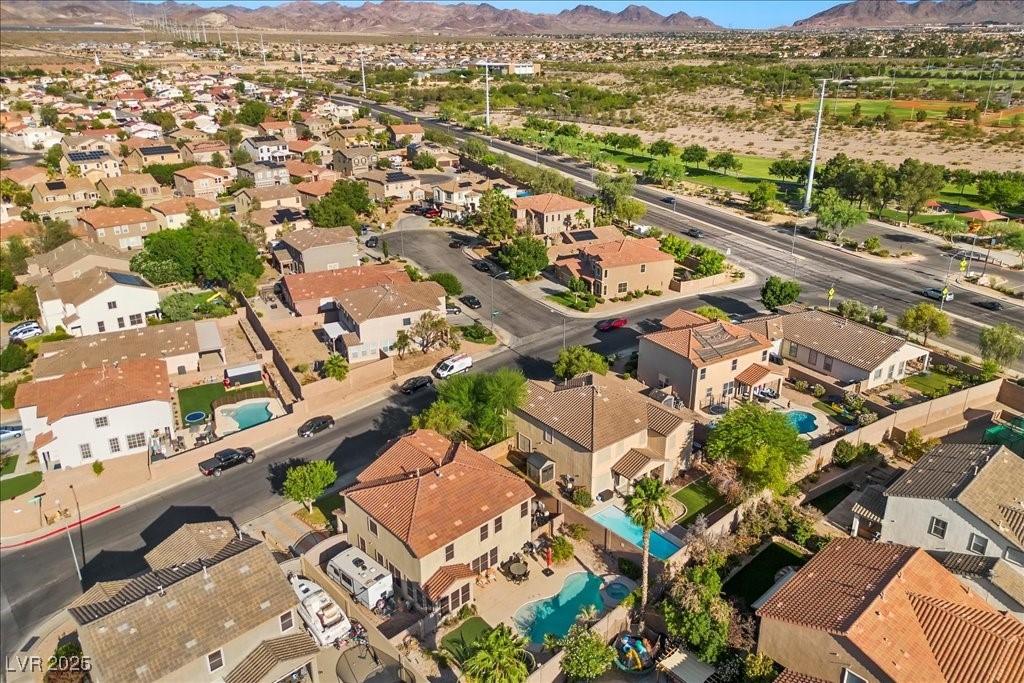 249 Cinnamon Ridge Way Henderson, NV 89015 - Photo 68 of 76 Aerial view of residential area featuring a mountain backdrop and a pool area