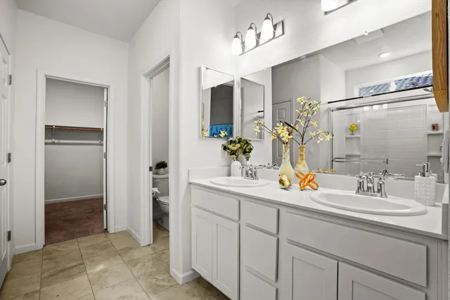 a bathroom with a sink double vanity and a mirror