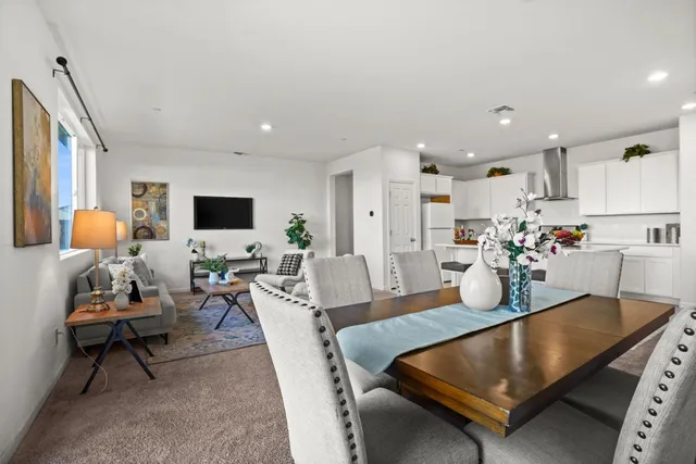 a living room with dining room and kitchen view