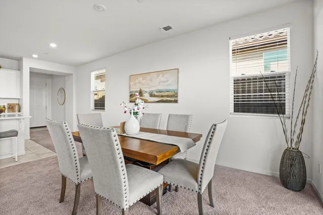 a dining room with furniture and window
