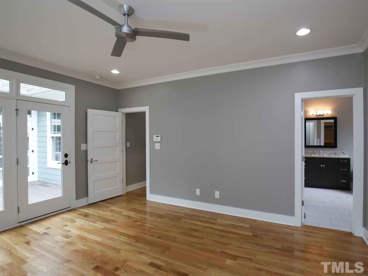 1101 North State Street Raleigh, NC 27604 - Photo 15 of 25 a view of an empty room with wooden floor and a ceiling fan