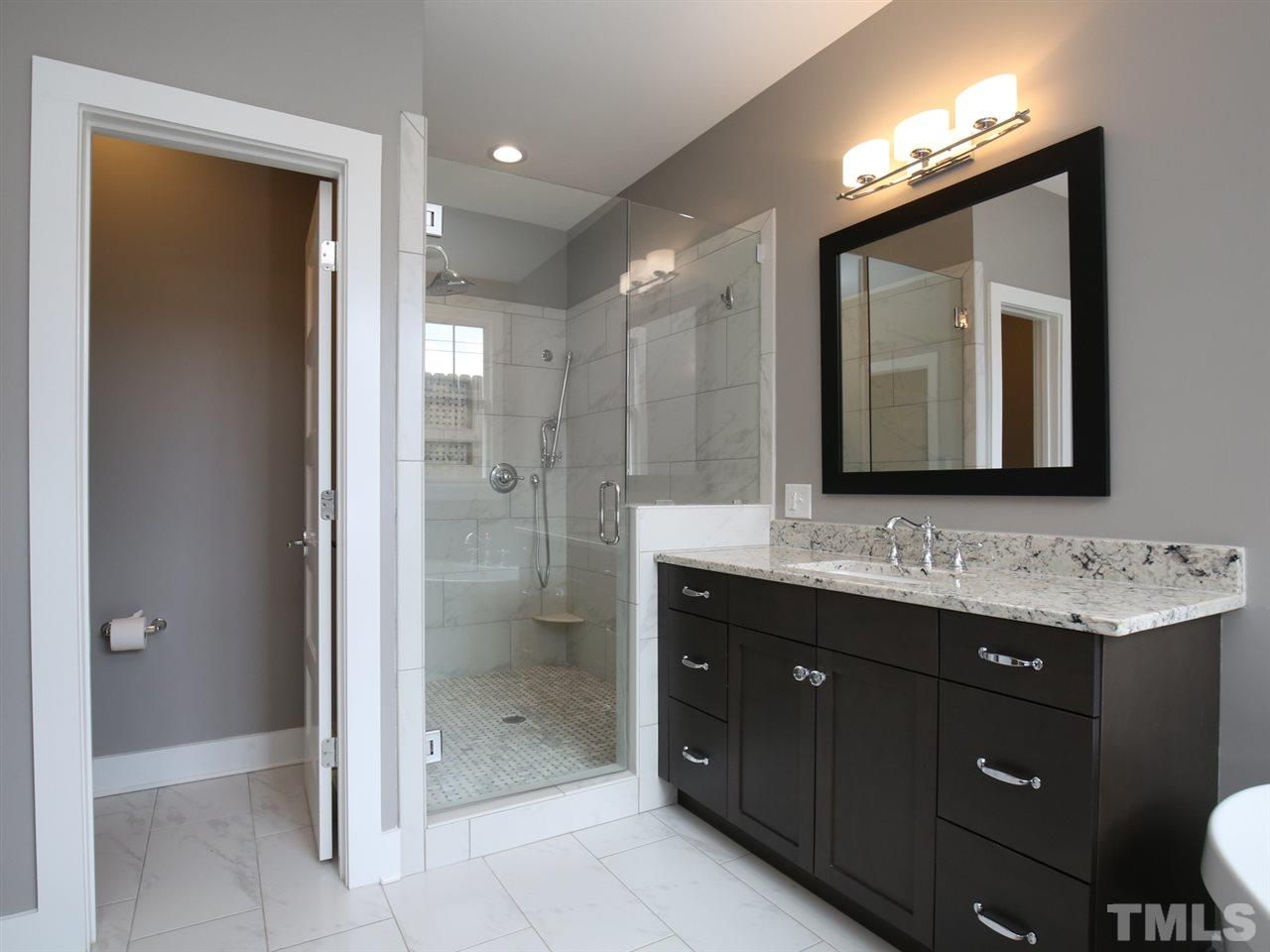 1101 North State Street Raleigh, NC 27604 - Photo 17 of 25 a bathroom with a double vanity sink mirror and shower