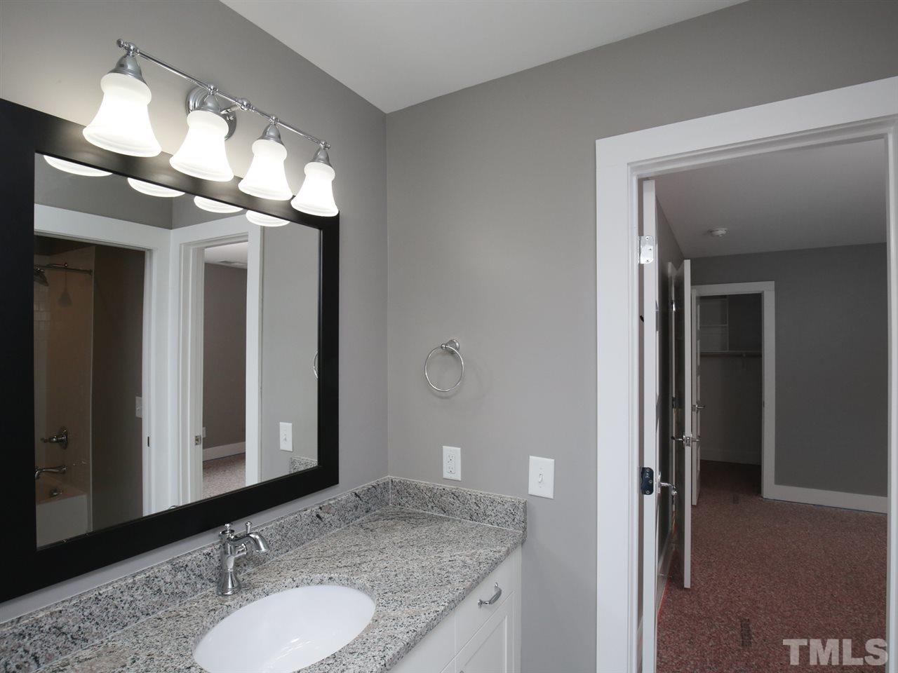 1101 North State Street Raleigh, NC 27604 - Photo 21 of 25 a bathroom with a granite countertop sink and a mirror