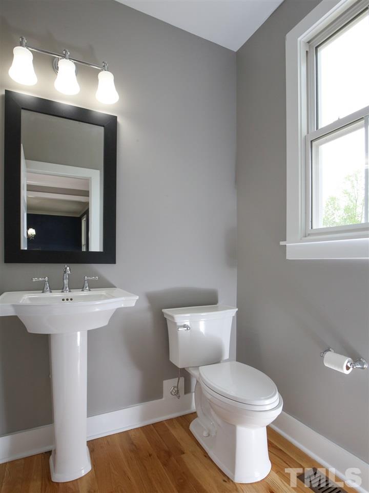 1101 North State Street Raleigh, NC 27604 - Photo 5 of 25 a bathroom with a toilet sink and mirror
