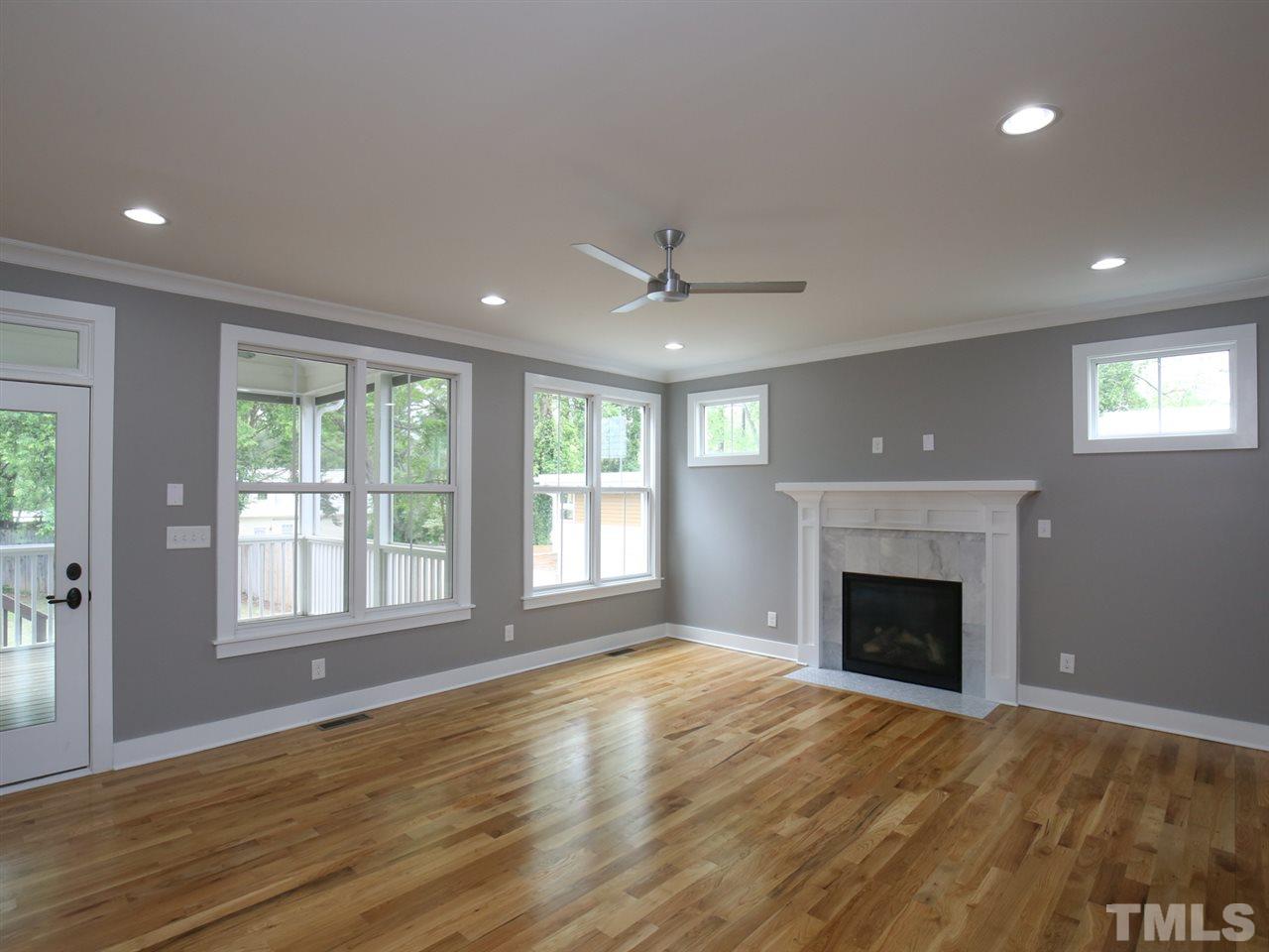 1101 North State Street Raleigh, NC 27604 - Photo 6 of 25 a view of an empty room with window and wooden floor