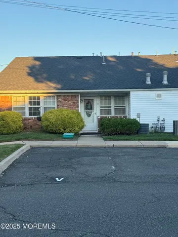 a living room with furniture and a lamp
