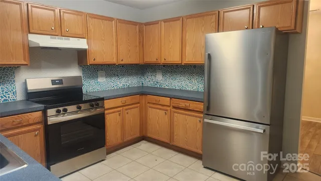 a kitchen with a refrigerator and cabinets
