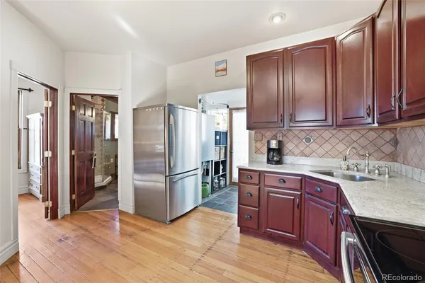 a kitchen with stainless steel appliances granite countertop a refrigerator stove and sink