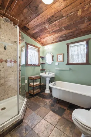 a bathroom with a toilet a sink and bathtub