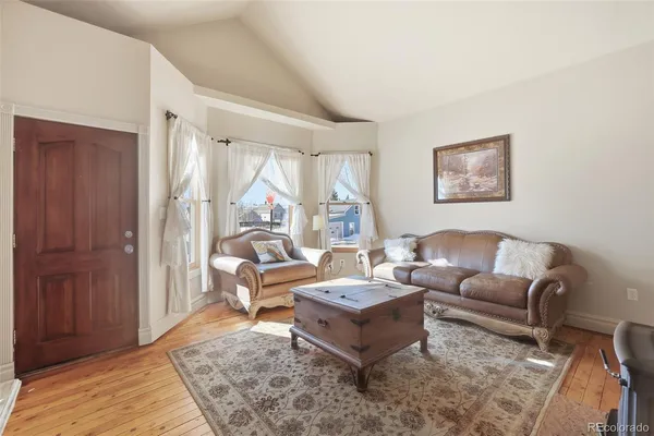 a living room with furniture and a rug