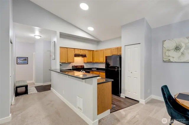 a kitchen with stainless steel appliances granite countertop a refrigerator and a stove top oven