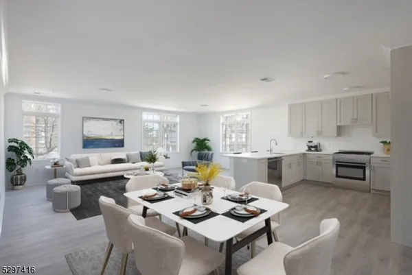 a living room with furniture kitchen view and a potted plant