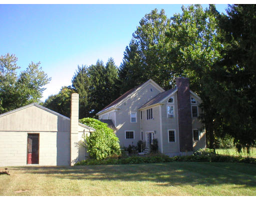 320 Still River Road Harvard, MA 01451 - Photo 12 of 14 a view of a white house next to a yard with big trees