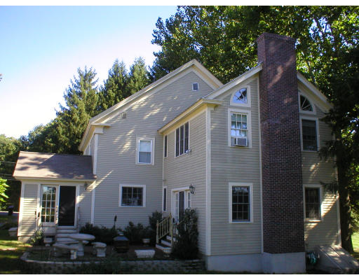 320 Still River Road Harvard, MA 01451 - Photo 2 of 14 a front view of a house with a yard and garage