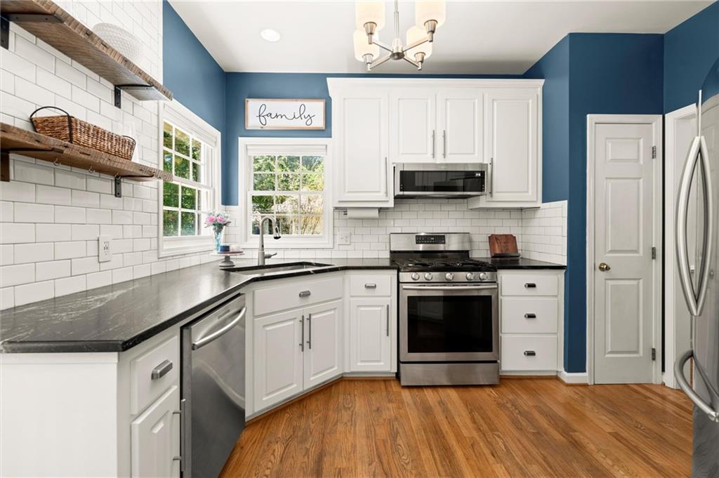 313 Thorntree Lane Canton, GA 30115 - Photo 14 of 51 a kitchen with stainless steel appliances granite countertop a stove a sink and a refrigerator