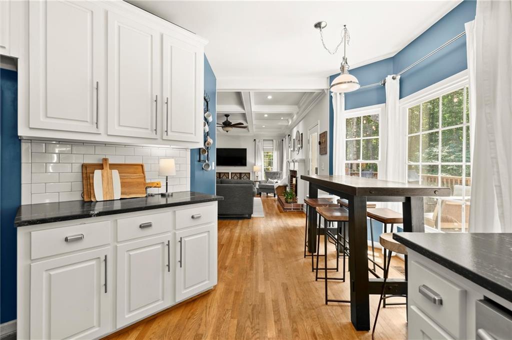 313 Thorntree Lane Canton, GA 30115 - Photo 15 of 51 a open kitchen with granite countertop a stove a sink a dining table and chairs with wooden floor