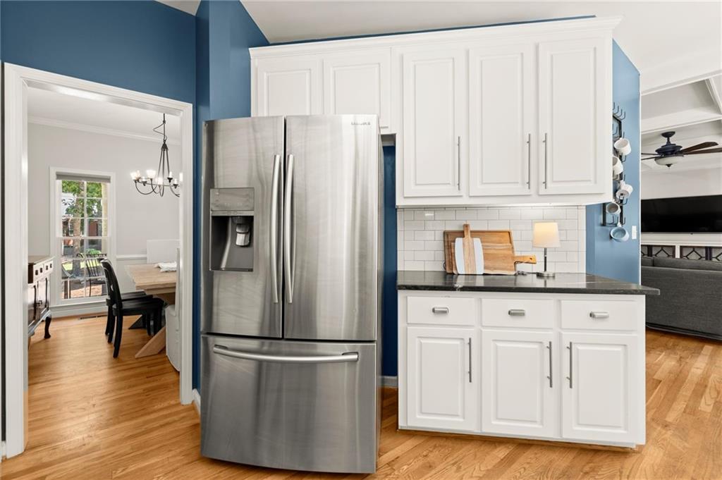 313 Thorntree Lane Canton, GA 30115 - Photo 17 of 51 a kitchen with stainless steel appliances granite countertop a refrigerator stove and white cabinets with wooden floor