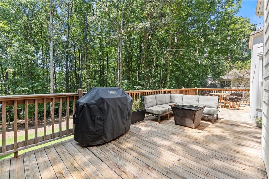 313 Thorntree Lane Canton, GA 30115 - Photo 18 of 51 a view of a roof deck with couches and wooden fence