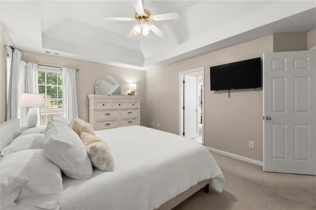313 Thorntree Lane Canton, GA 30115 - Photo 22 of 51 a bedroom with a bed a window and a flat screen tv