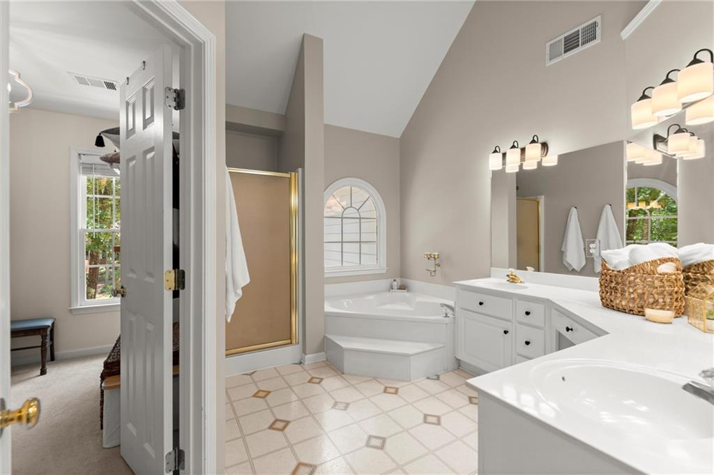 313 Thorntree Lane Canton, GA 30115 - Photo 24 of 51 a spacious bathroom with a tub sink and mirror
