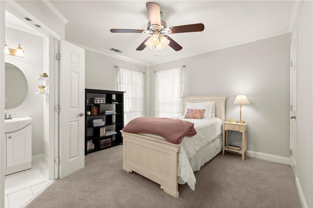 313 Thorntree Lane Canton, GA 30115 - Photo 29 of 51 a bedroom with a bed and a chandelier