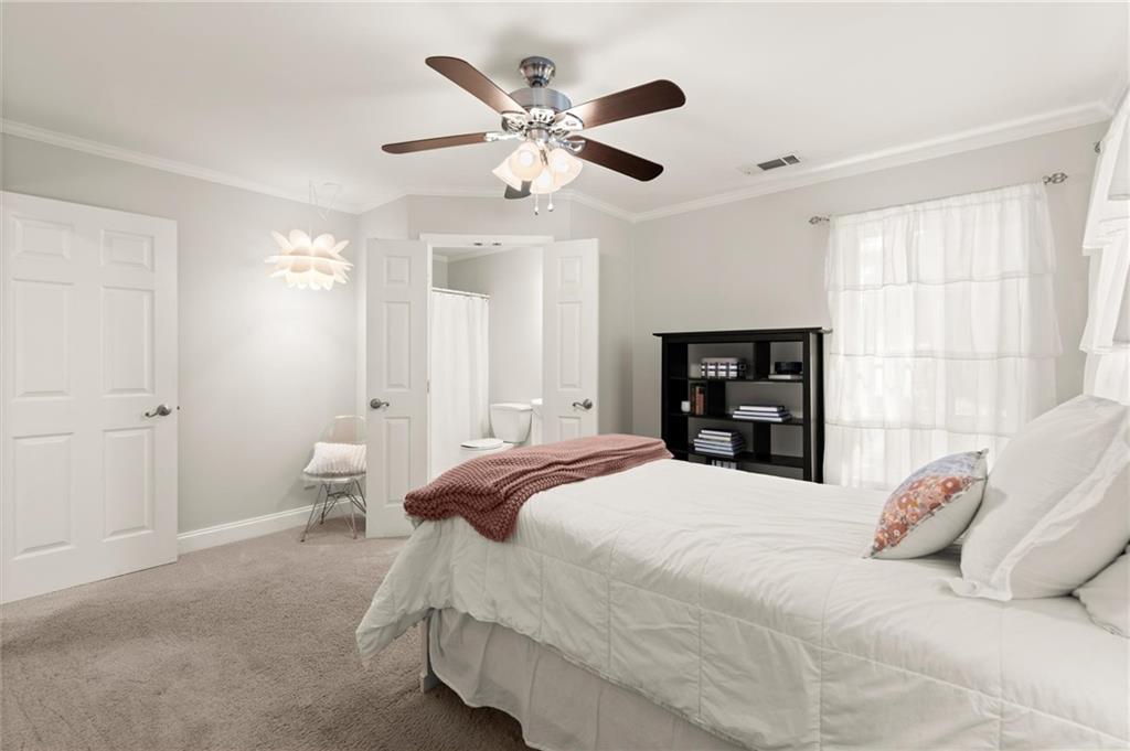 313 Thorntree Lane Canton, GA 30115 - Photo 30 of 51 a bedroom with a bed and a chandelier