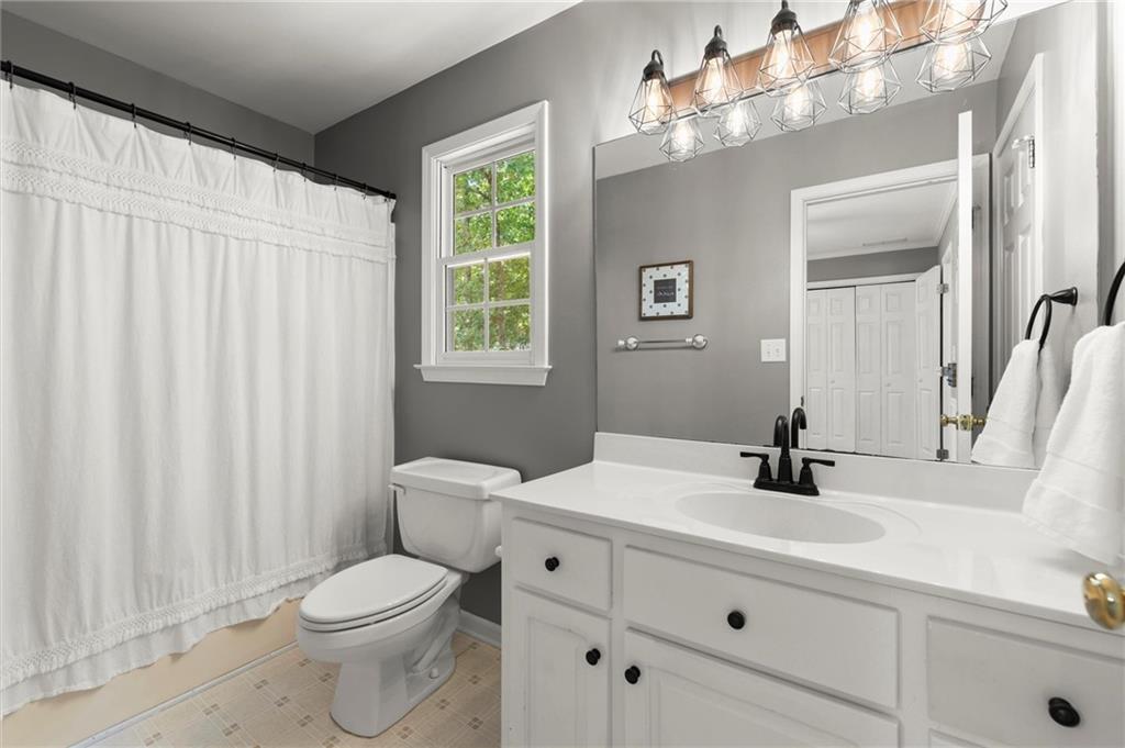 313 Thorntree Lane Canton, GA 30115 - Photo 35 of 51 a bathroom with a toilet a sink and a mirror