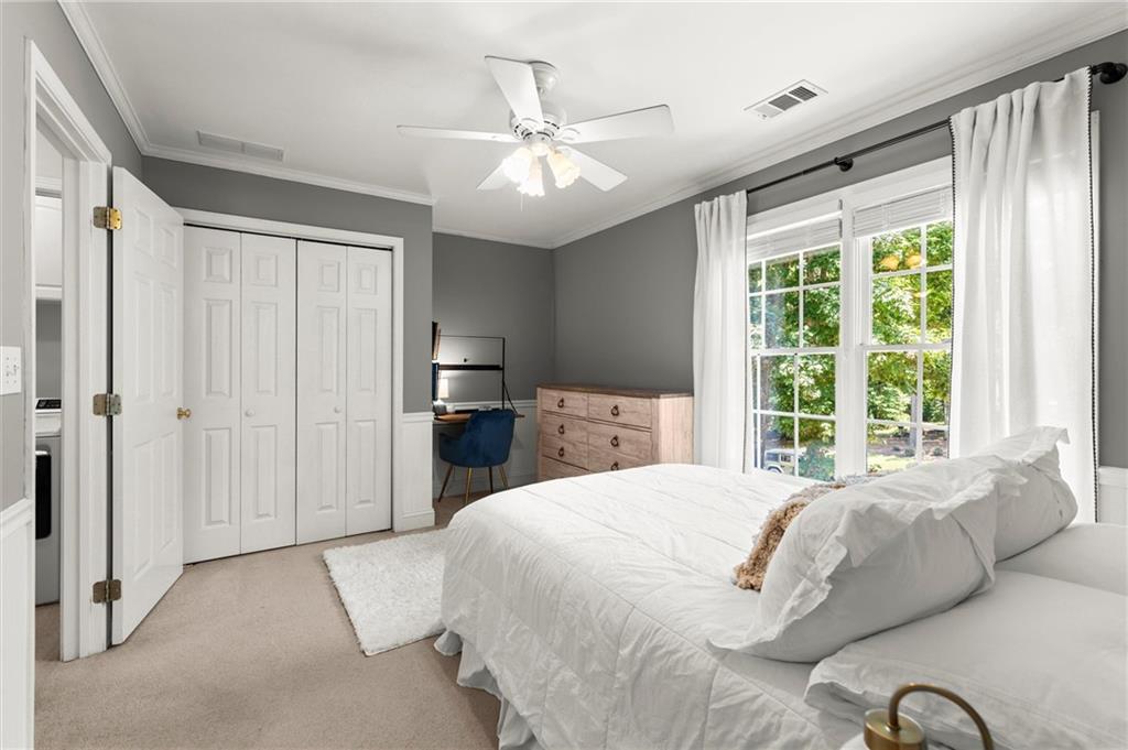313 Thorntree Lane Canton, GA 30115 - Photo 37 of 51 a spacious bedroom with a large bed and a chandelier fan