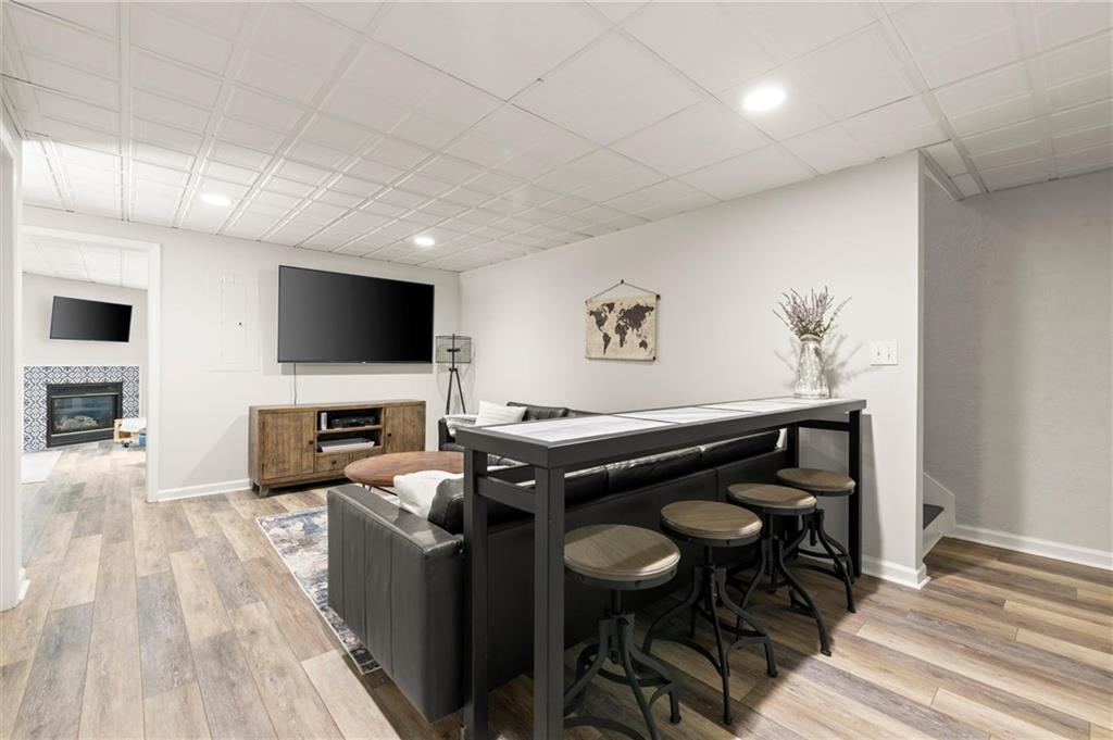 313 Thorntree Lane Canton, GA 30115 - Photo 39 of 51 a living room with furniture a flat screen tv and kitchen view