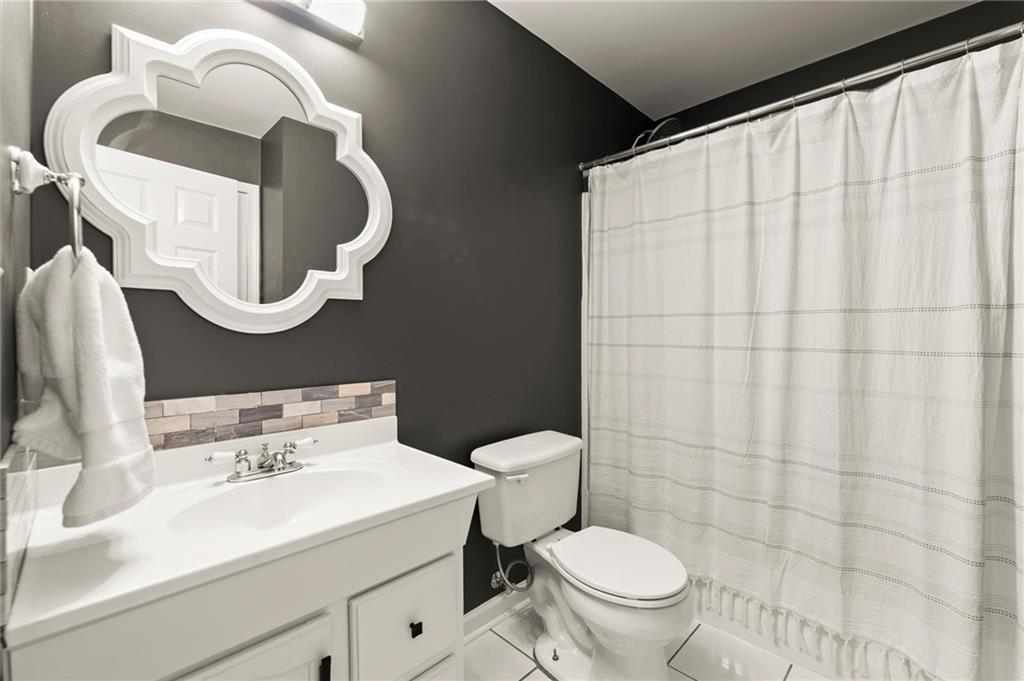 313 Thorntree Lane Canton, GA 30115 - Photo 45 of 51 a bathroom with a sink a toilet and a mirror
