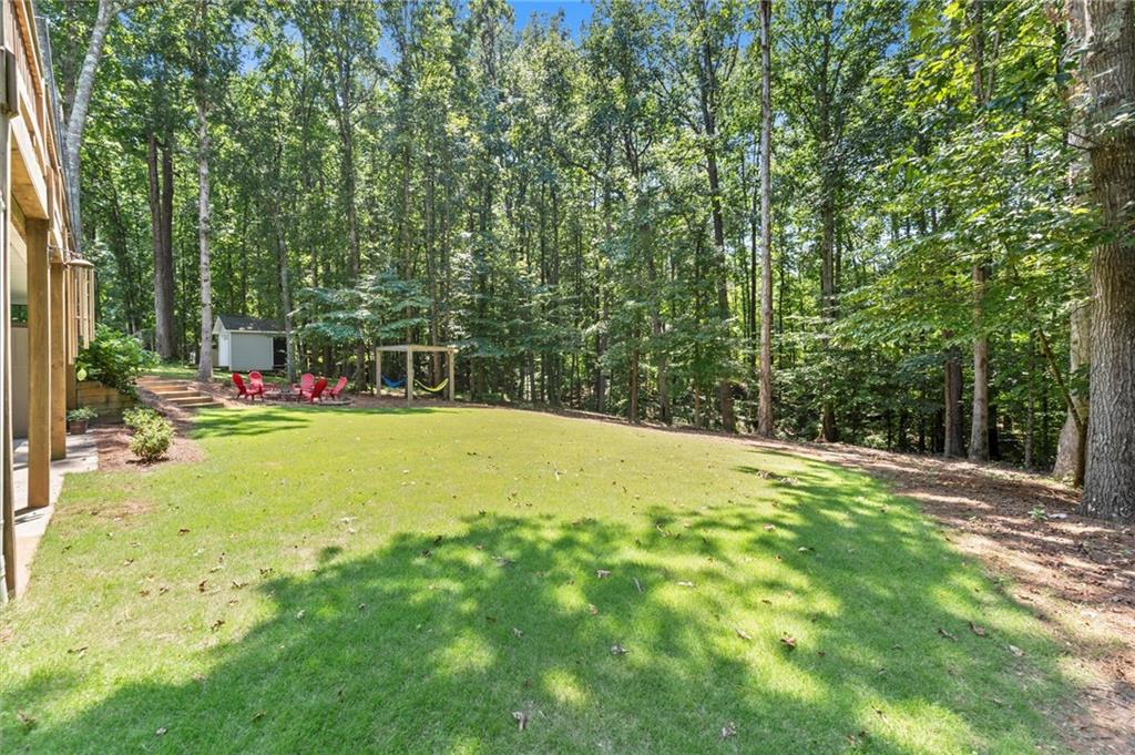 313 Thorntree Lane Canton, GA 30115 - Photo 48 of 51 a view of yard with swimming pool and trees in the background